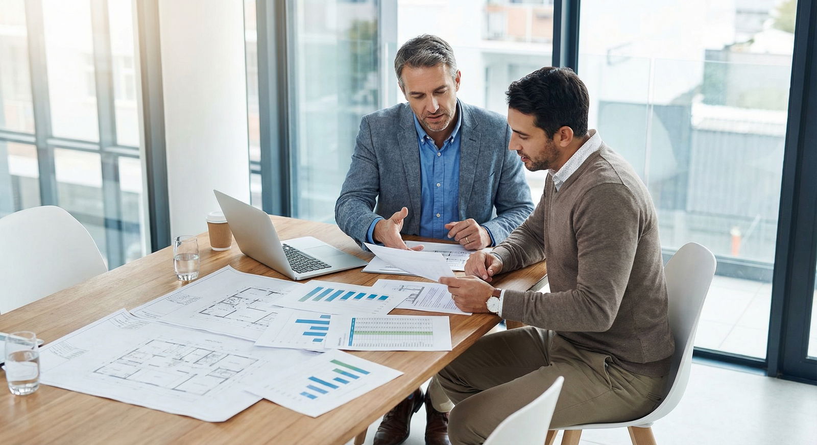 Physician meeting with a real estate agent to review investment properties - Real Estate Investment for Empower Your Finances