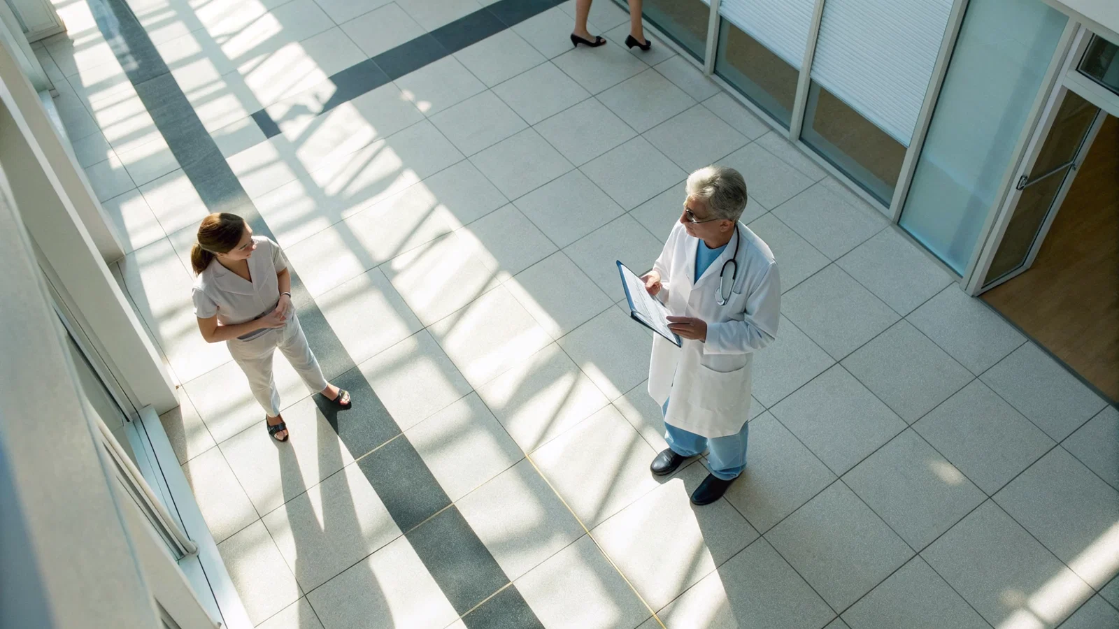Headline Cover: Medical Student presenting case data to Attending Physician and Resident